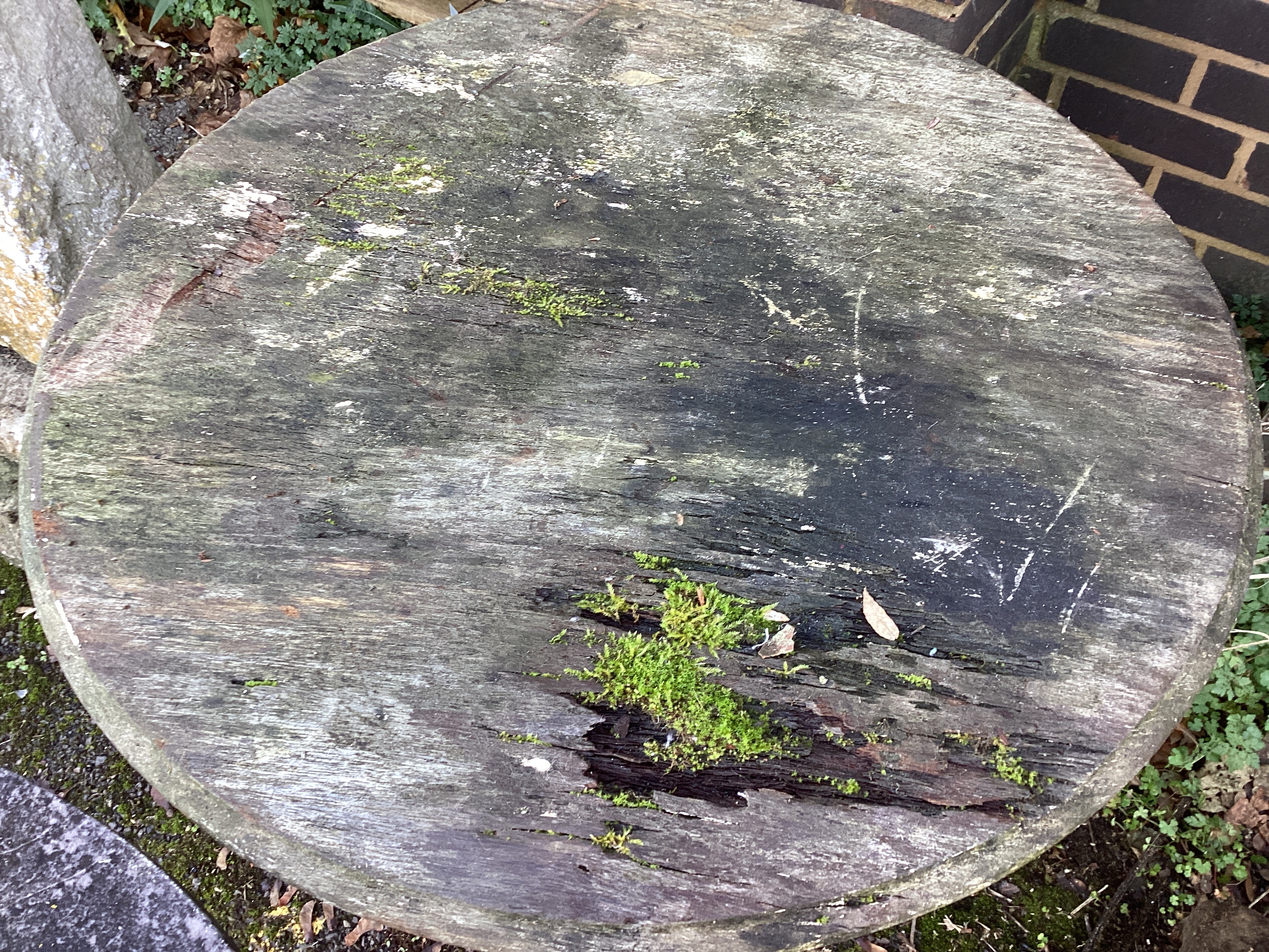 A near pair of Victorian cast iron Britannia pub tables, one with weathered stone top, the other wooden top diameter 63cm, height 75cm
